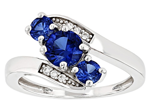 1.33ctw Round Lab Created Blue Sapphire With .07ctw White Zircon Rhodium Over Silver Bypass Ring - Size 10