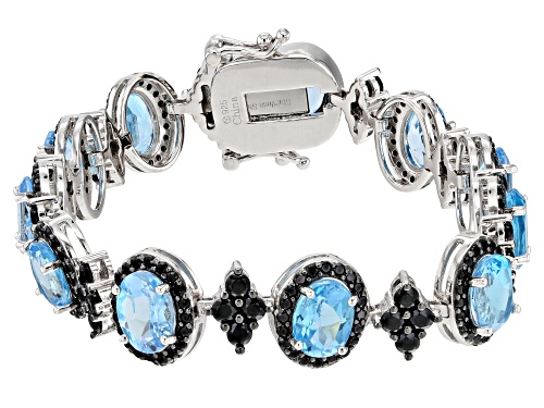 Photo of 12.15ct Oval Swiss Blue Topaz With 5.00ct Round Black Spinel Rhodium Over Sterling Silver Bracelet - Size 7.25