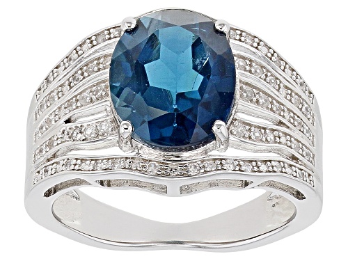 Photo of 3.74ct Oval London Blue Topaz With .20ctw Zircon Rhodium Over Sterling Silver Ring - Size 9