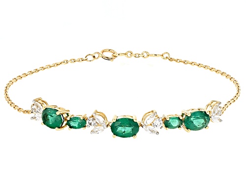 Photo of Pre-Owned 2.75ctw Oval Emerald Color Apatite And .96ctw White Zircon 10k Yellow Gold Bracelet - Size 7.5