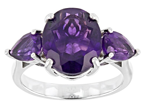 Photo of Pre-Owned 3.50ct Oval And 0.85ctw Pear shaped African Amethyst Rhodium Over Sterling Silver 3-Stone - Size 9
