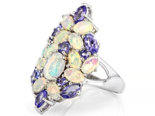 1.71ctw Oval Ethiopian Opal with 1.29ctw Mixed Shape Tanzanite Rhodium Over Sterling Silver Ring - Size 6