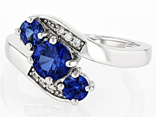 1.33ctw Round Lab Created Blue Sapphire With .07ctw White Zircon Rhodium Over Silver Bypass Ring - Size 10