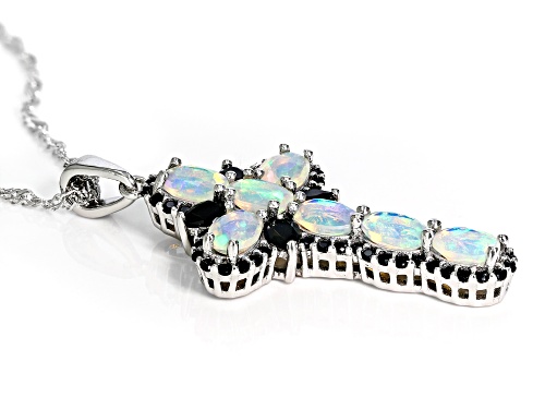 1.76ctw Oval Ethiopian Opal With .90ctw Black Spinel Rhodium Over Silver Cross Pendant With Chain