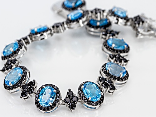 12.15ct Oval Swiss Blue Topaz With 5.00ct Round Black Spinel Rhodium Over Sterling Silver Bracelet - Size 7.25