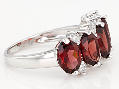 4.90ctw Oval Red Garnet With .45ctw Round White Zircon Rhodium Over Sterling Silver Ring - Size 7