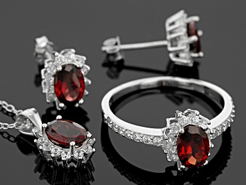 4.00ctw Oval Red Garnet And1.41ctw Round White Zircon Silver Ring, Earrings And Pendant W/Chain Set