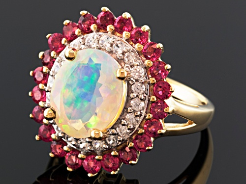 1.32ct Oval Ethiopian Opal With .85ctw Round Red Spinel And .36ctw White Zircon 10k Yellow Gold Ring - Size 12