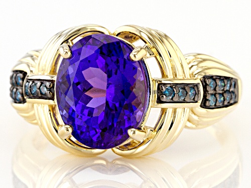 2.72ct Oval Tanzanite And 0.13ctw Round Blue Diamond 14K Yellow Gold Ring - Size 7