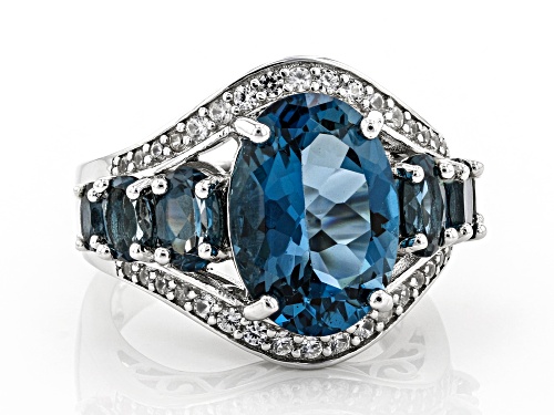 6.80ctw Oval London Blue Topaz and .50ctw Round White Zircon Rhodium Over Sterling Silver Ring - Size 7
