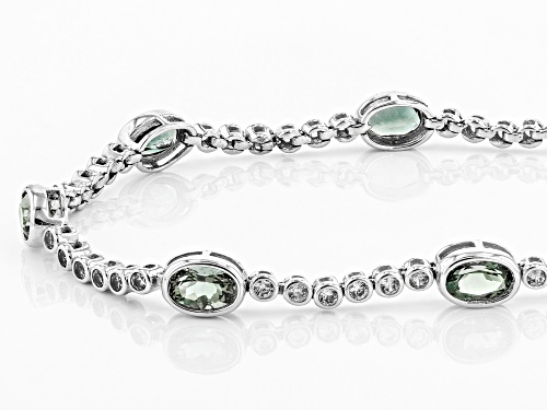 Pre-Owned 3.20ctw oval Oregon green sunstone with 1.22ctw round white zircon 10K white gold bracelet - Size 7.25