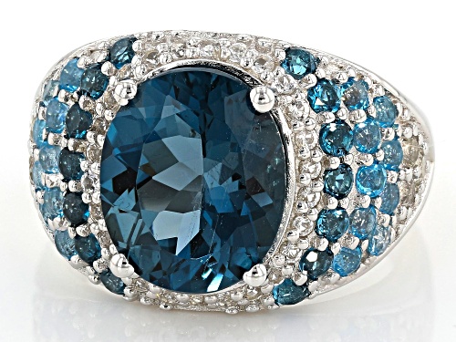 5.61ct Oval & .48ctw Round London Blue, 1.06ctw Swiss Blue & White Topaz Rhodium Over Silver Ring - Size 7