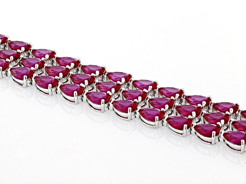 52.79ctw Pear Shape Lab Created Ruby Rhodium Over Sterling Silver Tennis Bracelet - Size 8