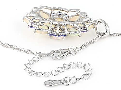 3.57ctw Pear Shape Ethiopian Opal With .74ctw Round Tanzanite Rhodium Over Silver Pendant/Chain