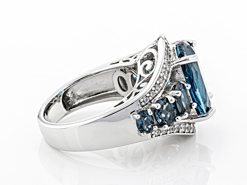 6.80ctw Oval London Blue Topaz and .50ctw Round White Zircon Rhodium Over Sterling Silver Ring - Size 8