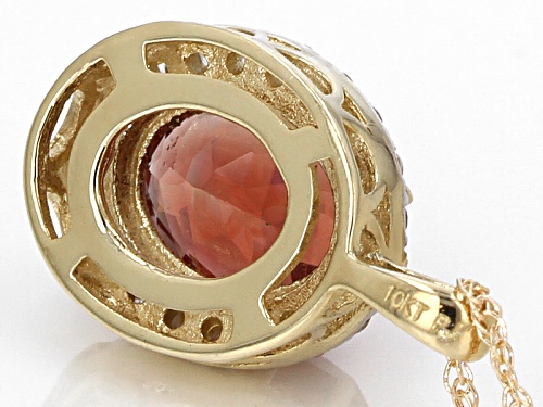 .90ct Oval Oregon Sunstone With .20ctw Round White Zircon 10k Yellow Gold Pendant With Chain.