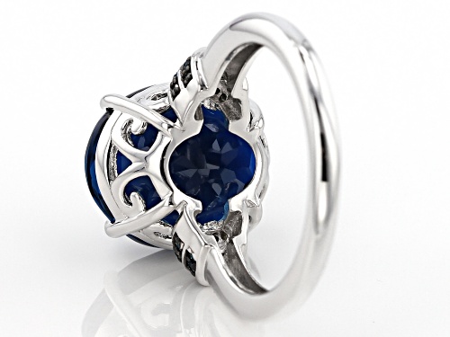 8.16CT OVAL LONDON BLUE TOPAZ WITH .10CTW ROUND BLUE DIAMOND RHODIUM OVER STERLING SILVER RING - Size 9