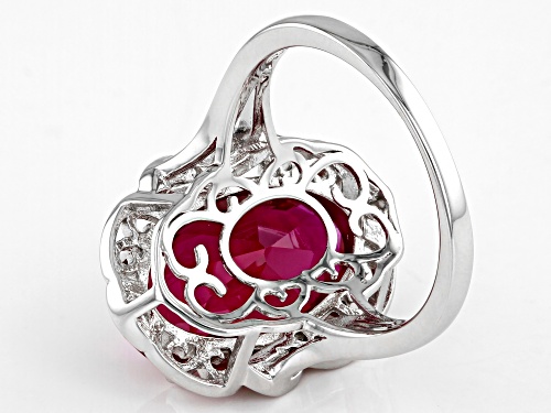 7.28ct Oval Lab Created Ruby With 0.07ctw Round White Zircon Rhodium Over Sterling Silver Ring - Size 7