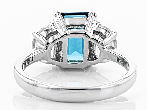 2.55CT EMERALD CUT LONDON BLUE TOPAZ WITH 1.19CTW CRESCENT WHITE ZIRCON RHODIUM OVER SILVER RING - Size 10