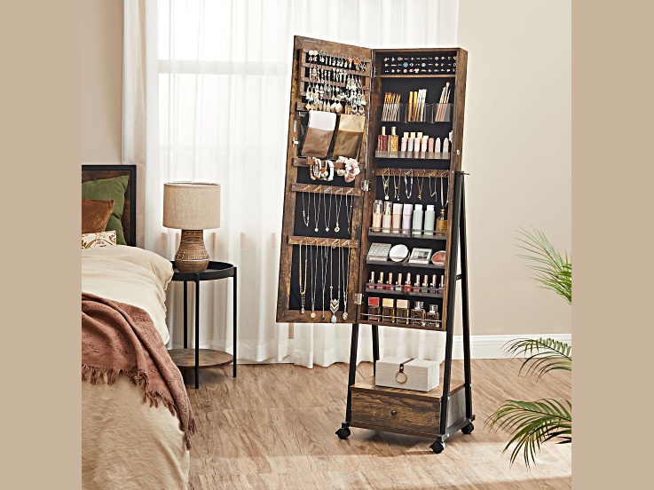 Open jewelry cabinet on a stand filled with necklaces, bracelets, and makeup organized in compartments.