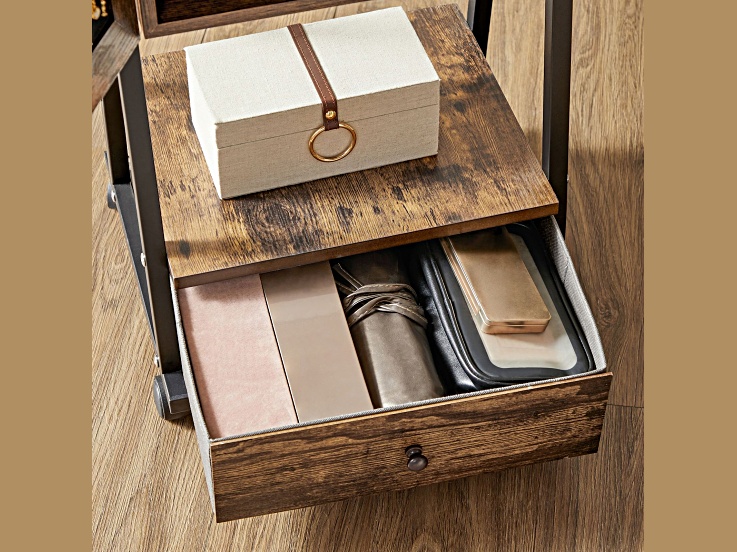 Open drawer showing organized accessories and a small box on top of the cabinet.
