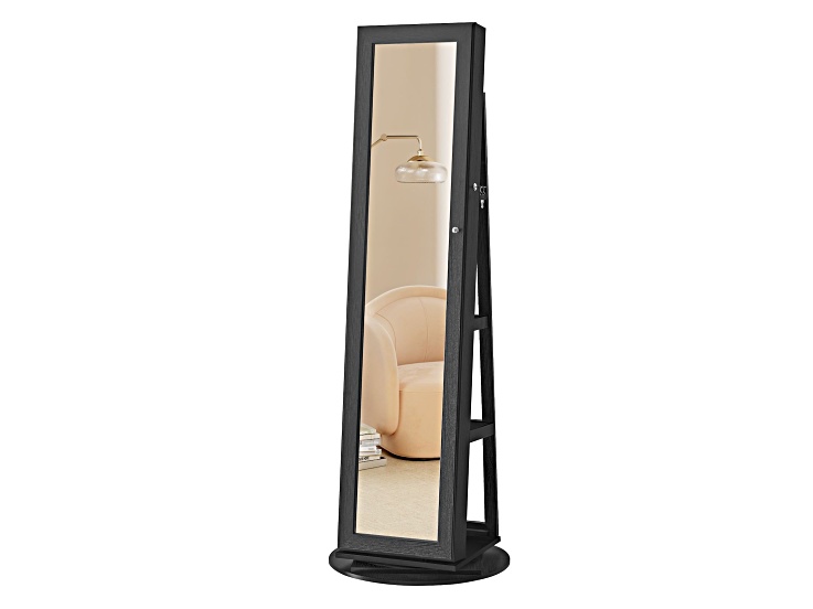 Full-length mirror jewelry cabinet on a stand, reflecting a living room scene.