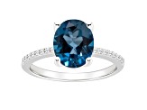 10x8mm Oval London Blue Topaz and 1/10 ctw Diamond Rhodium Over Sterling Silver Ring