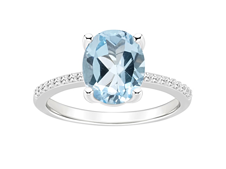 10x8mm Oval Sky Blue Topaz and 1/10 ctw Diamond Rhodium Over Sterling Silver Ring