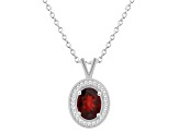 8x6mm Oval Garnet 1/8 ctw Diamond Rhodium Over Sterling Silver Halo Pendant with Chain