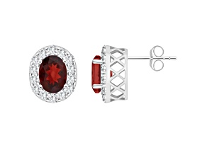 8x6mm Oval Garnet And White Topaz Accent Rhodium Over Sterling Silver Halo Stud Earrings