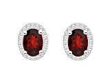 7x5mm Oval Garnet 1/5 ctw Diamond Rhodium Over Sterling Silver Halo Stud Earrings