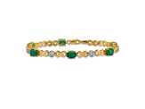 14k Yellow Gold and Rhodium Over 14k Yellow Gold Diamond and Emerald Infinity Bracelet