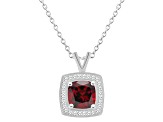 7mm Cushion Garnet 1/7 ctw Diamond Rhodium Over Sterling Silver Halo Pendant with Chain