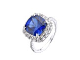 Lab Created Blue Sapphire and White Topaz Rhodium Over Sterling Silver Halo Ring