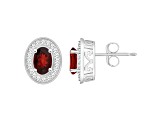 6x4mm Oval Garnet 1/5 ctw Diamond Rhodium Over Sterling Silver Halo Stud Earrings