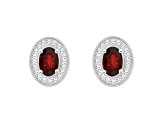 6x4mm Oval Garnet 1/5 ctw Diamond Rhodium Over Sterling Silver Halo Stud Earrings