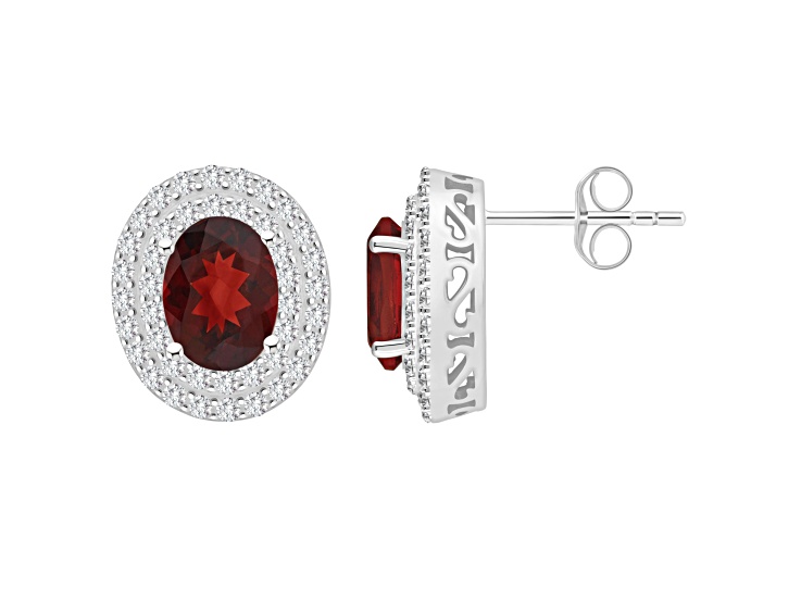 8x6mm Oval Garnet And White Topaz Accent Rhodium Over Sterling Silver Double Halo Stud Earrings