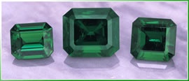 three loose emerald gemstones