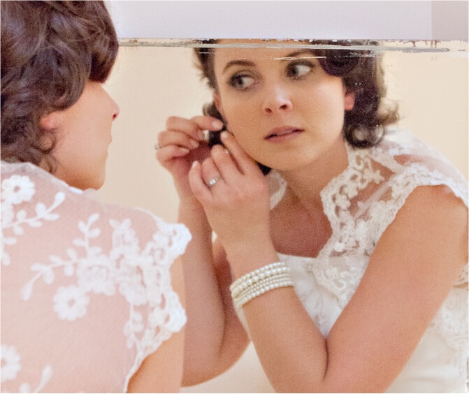 Bride putting on jewelry
