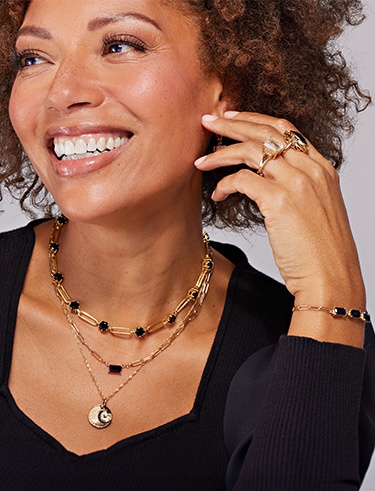Smiling woman wearing yellow gold jewelry