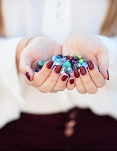 Woman holding assorted beads 
