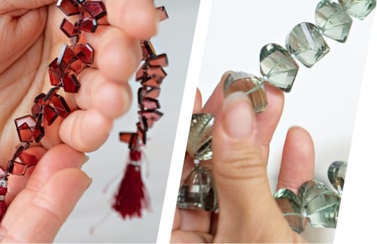 model holding maroon and green strands of beads 